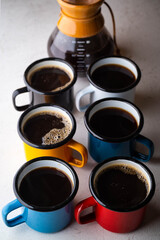 coffee in many colorful mugs on white background