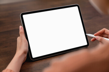 Mock up of woman hand holding digital tablet and touching blank screen.