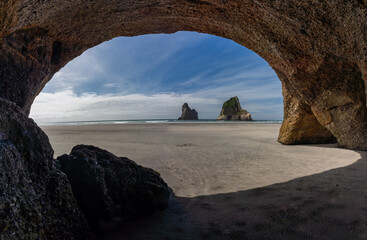 View of Wharariki Beach from inside a cave in New Zealand