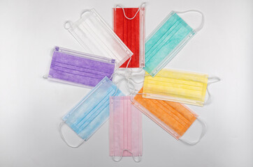 colored masks on white background. multi-colored Surgical protective mask. Medical respiratory bandage face. 100 Days Masking Challenge