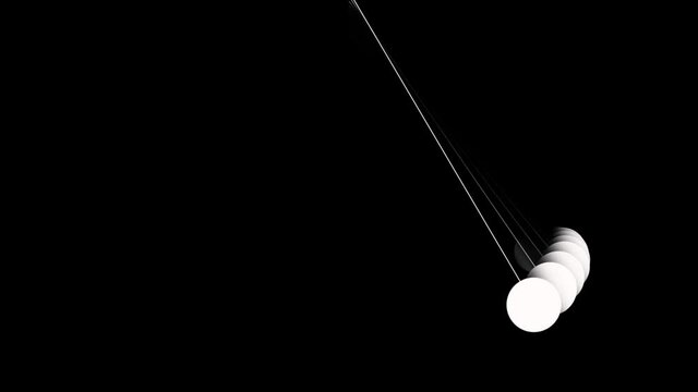 Freely swinging pendulums with motion, Mesmerizing Newtons Cradle, with its suspended metallic spheres, swings rhythmically against a stark black background.
