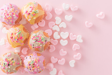 small colorful cakes with pink and white heart shaped marshmallows