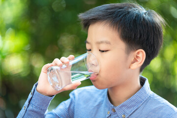 Young Asian boy drink water
