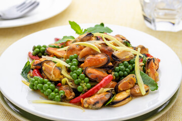 Stir-fried mussel meat with herbal vegetables or mussel pad cha Thai