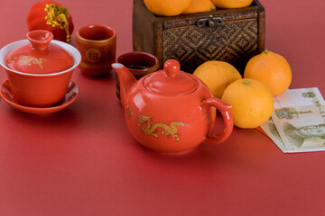 Chinese New Year decoration festival decorations of accessories in traditional container mandarin oranges on red background