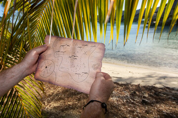 Searching for a buried treasure with a map on a deserted tropical island