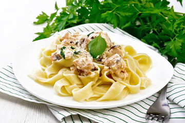 Pasta with salmon in cream on white board
