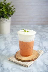 Thai milk tea on top cream cheese in glass plastic.