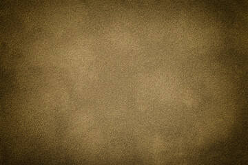 Brown matte background of suede fabric with vignette, closeup. Velvet textile.
