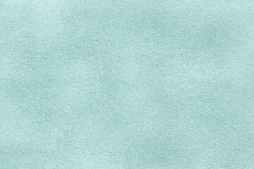 Light blue matte background of suede fabric, closeup. Velvet texture of textile
