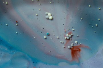 Painted Galaxy Art Created in Oil and Milk. Galaxies evolve in this artistic science experiment. Alien landscape. Purple, red and blue abstract formations take shape in an alternate universe.