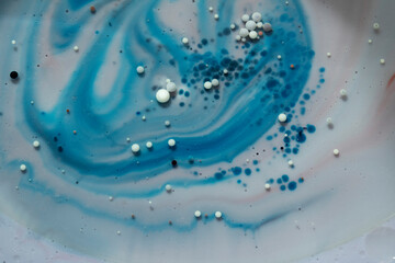 Fototapeta premium Painted Galaxy Art Created in Oil and Milk. Galaxies evolve in this artistic science experiment. Alien landscape. Purple, red and blue abstract formations take shape in an alternate universe.