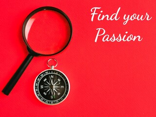 Text Find your Passion on red background with compass and magnifying glass.