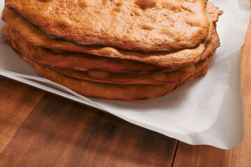 Empty cake crust on wooden rural kitchen table. Bakery thematic background.