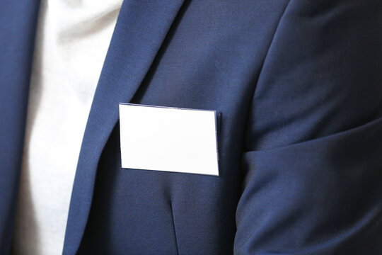 Elegant man in suit with blank badge, closeup