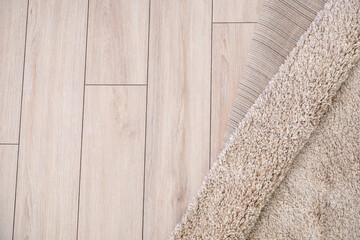 Beautiful soft carpet on wooden floor