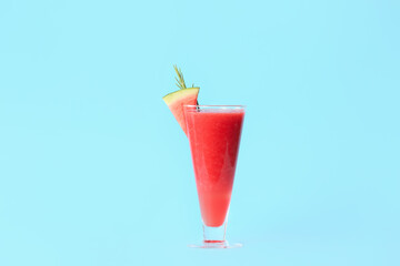 Glass of fresh watermelon juice on color background