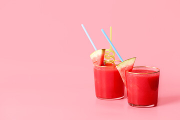 Glasses of fresh watermelon juice on color background