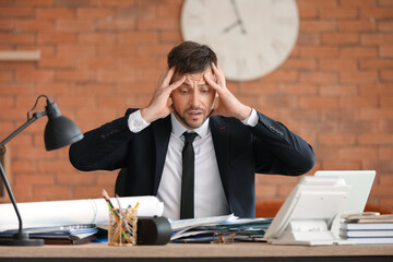Stressed businessman trying to meet deadline in office