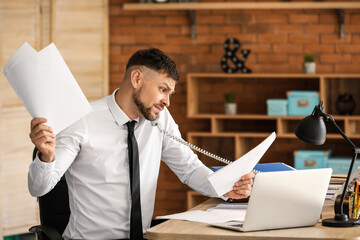 Businessman trying to meet deadline in office