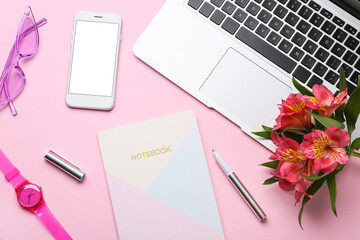 Composition with laptop, flowers, notebook and accessories on color background