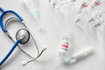 Vaccine for immunization against COVID-19 and stethoscope on table