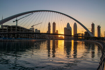 Fototapeta na wymiar Dubai, UAE - 01.08.2021 Bridge over a Dubai Water canal known as Tolerance bridge. Outdoors