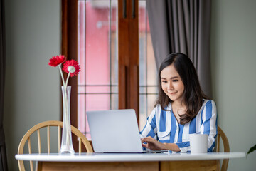 beutiful woman working on laptop in the room.