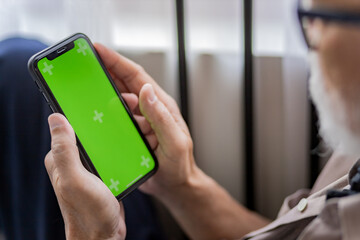 Senior use greenscreen smartphone. 