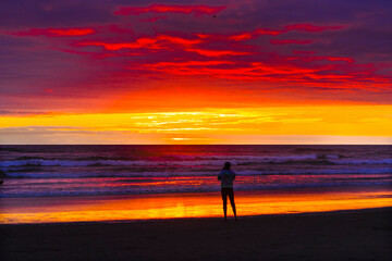 Fototapeta na wymiar Meditation Watching Colorful Sunset Ocean Canon Beach Oregon