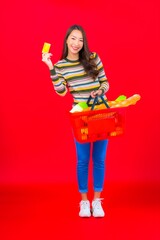 Portrait beautiful young asian woman with grocery basket from supermarket