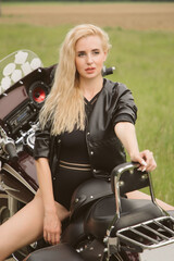 Fototapeta na wymiar Blonde girl on a motorcycle