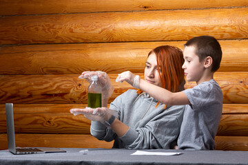 Chemistry education and study concept. a little boy and his mother look at a bottle in which the color changes successively as a result of a chemical reaction. Experiments for children at home