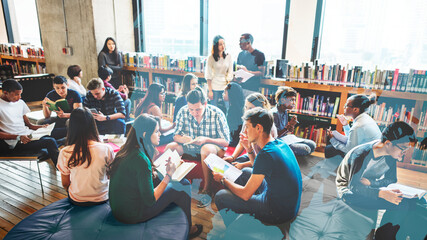 Group of diverse students working in a school library - obrazy, fototapety, plakaty