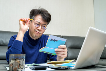 Middle-aged Asian man preparing for tax return.