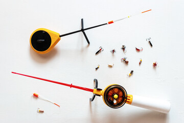winter fishing rods and jigs on a white background
