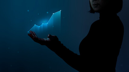 Business person holding a digitally generated growing graph