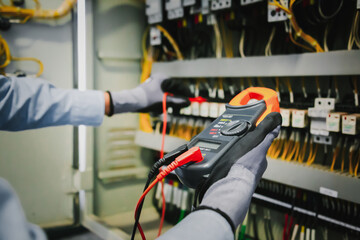 Electrical engineers test electrical installations and wiring on protective relays, measuring them...