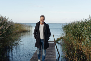 Trendy man in casual clothes posing on a jetty