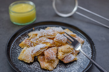 Austrian cuisine. Torn pancake (or omelet) kaiserschmarrn with honey, powdered sugar