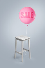 White wooden table on a gray background with small balloon
