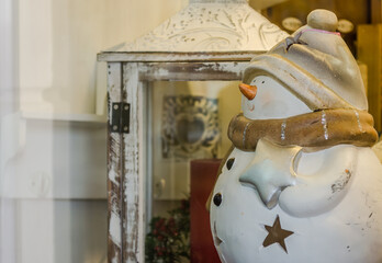 Novi Sad, Serbia - December 29. 2020: Ceramic snowman in the window of an antique shop in Novi Sad, Serbia 