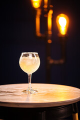 Glass of margarita cocktail with salt on the round table