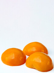 Peach in syrup surrounded by white background