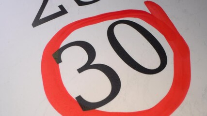 30 - Marking the date in the calendar with a red marker. The thirtieth day of the month. The hand circles the date in the calendar with a pen. Number in the red circle close up