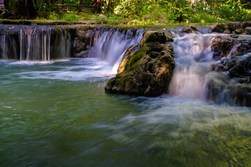 Fototapeta na wymiar Beautiful waterfall in tropical rainforest green tree background
