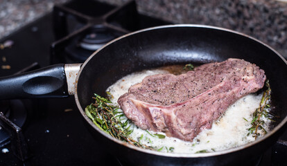 An image of a steak pan seared in butter and rosemary
