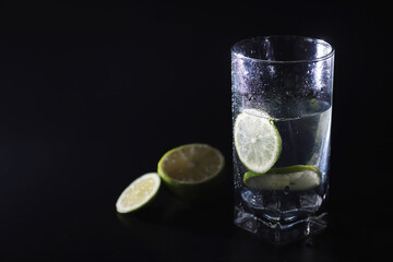 Lime water. Drinking water with fresh lime. Mineral water. Healthy, mineral-rich, refreshing water with lime.