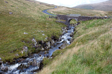A small stone bridge over a stream, minor road above Talla Reservoir, Southern Uplands, Scottish Borders, Scotland, UK.