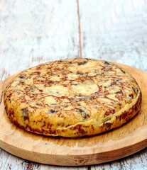 Spanish tortilla surrounded by rustic background